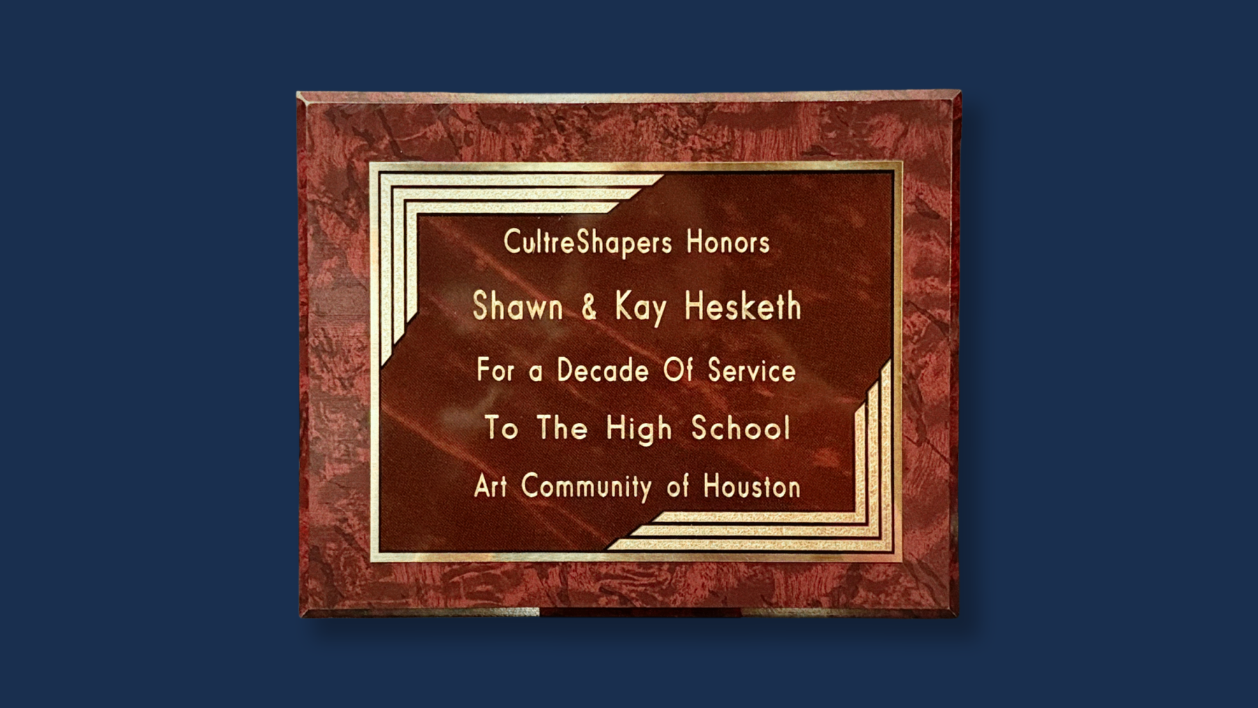 A plaque reads, “Culture Shapers Honors Shawn & Kay Hesketh for a Decade of Service to the High School Art Community of Houston”