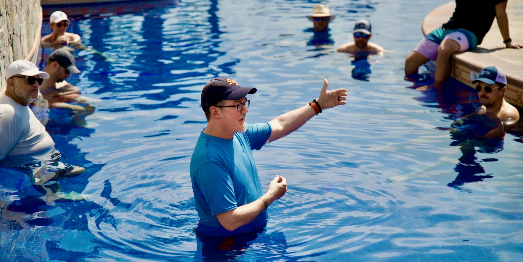 Shawn speaking at the one-of-a-kind business event where all the sessions take place in a pool — CaboPress.